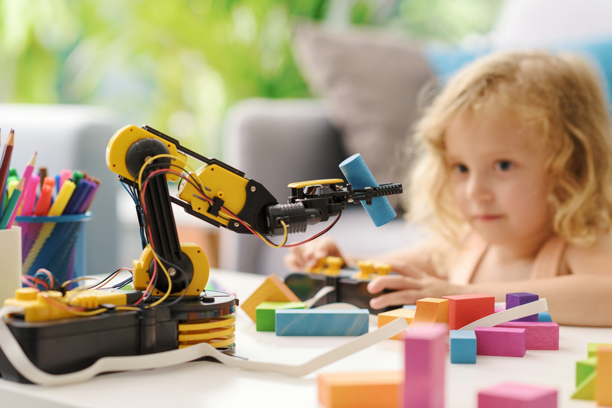 Child playing with a robotic arm toy